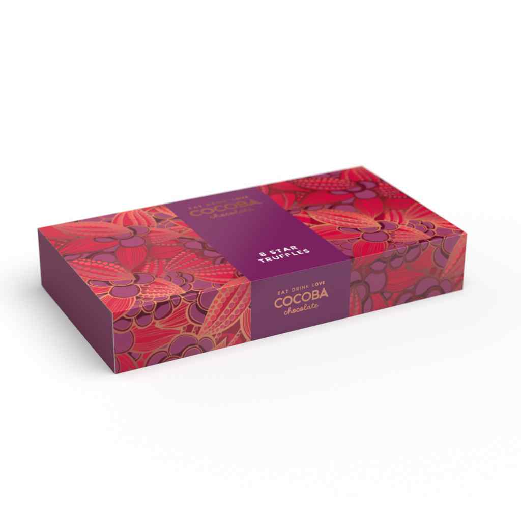 A festive box of Cocoba Chocolate Christmas Star Truffles, featuring a vibrant red and pink patterned design with a central purple label band.