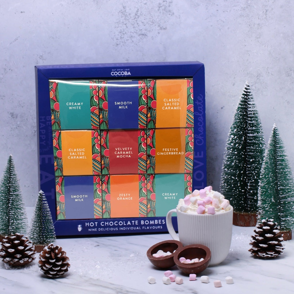 Colourful Gift Box containing a variety of 9 different flavoured Hot Chocolate Bombs, in a Christmas setting
