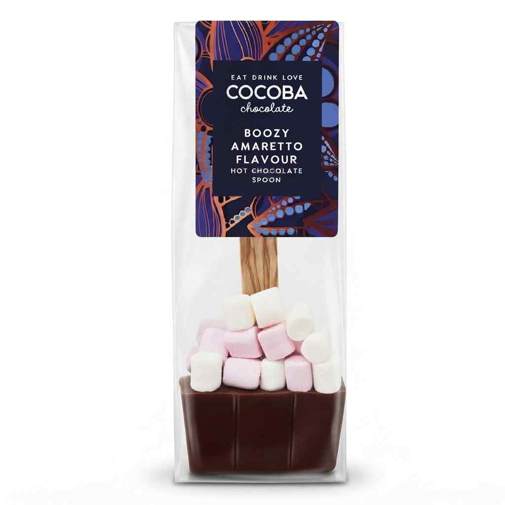 A packaged chocolate hot chocolate spoon from Cocoba Chocolate, featuring a dark brown chocolate base topped with pink and white marshmallows, in a clear bag with a dark purple label.
