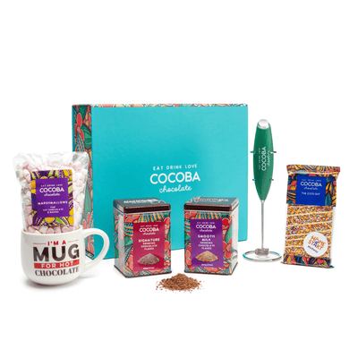 Cocoba chocolate gift set with mug, packaging, and mixer on a white background