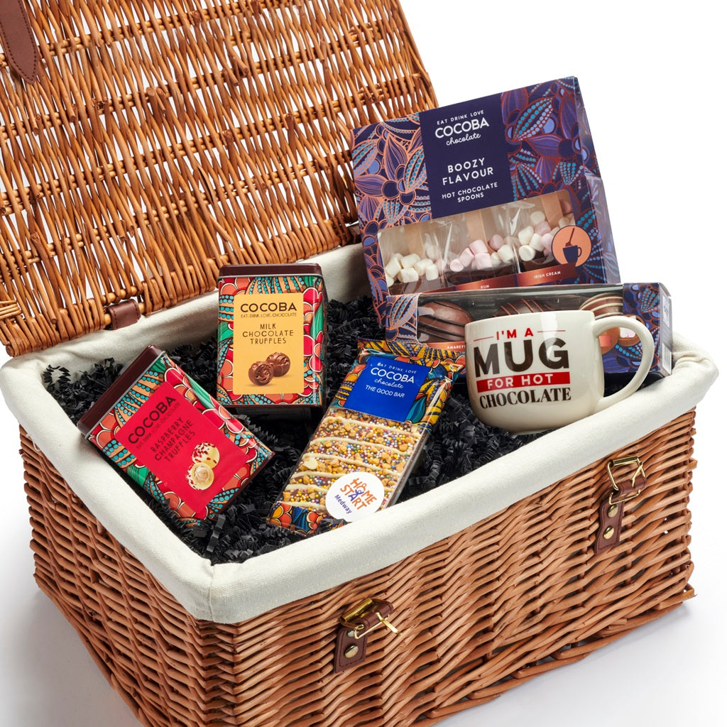 Wicker gift basket with boozy chocolate truffles, and alcohol flavoured hot chocolates, plus a Cocoba mug and chocolate bar.
