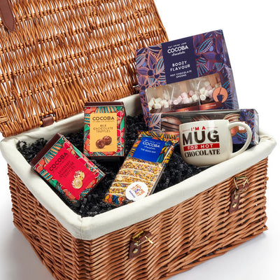 Wicker gift basket with boozy chocolate truffles, and alcohol flavoured hot chocolates, plus a Cocoba mug and chocolate bar.