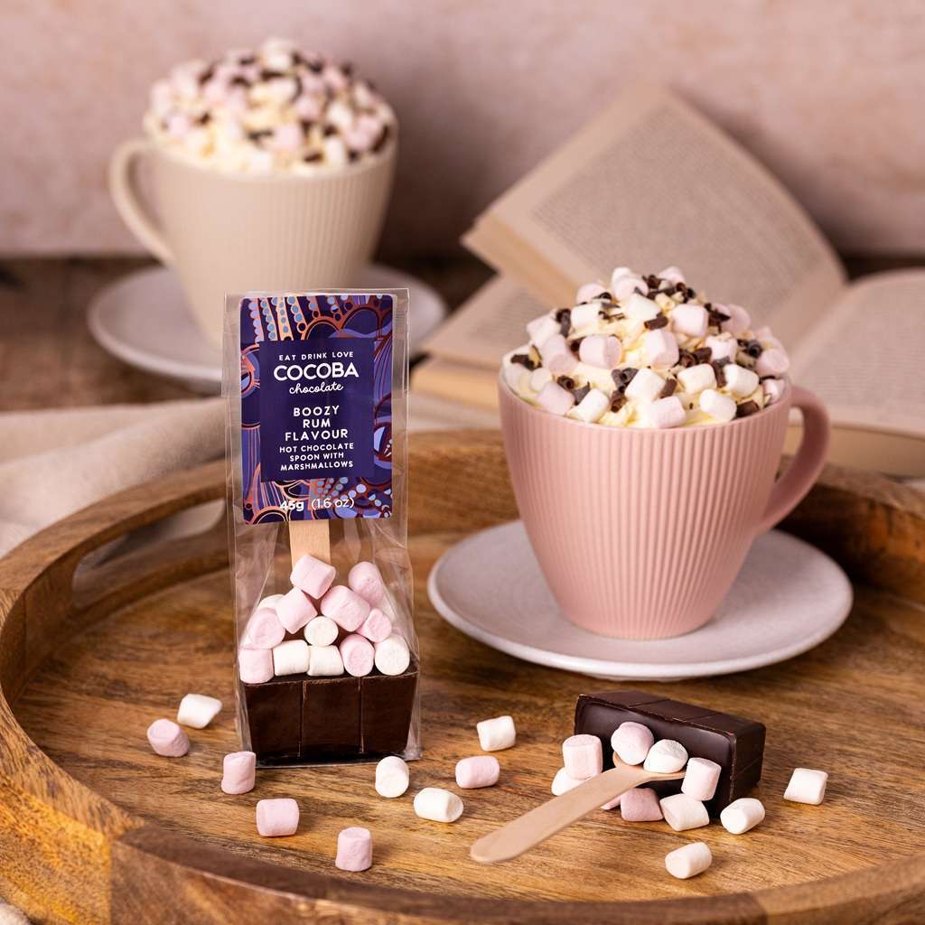 COCOBA Rum flavoured dark chocolate hot chocolate spoon with marshmallows and rum flavor on a wooden tray.