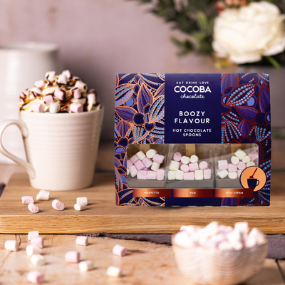 Cocoba Boozy Flavour hot chocolate spoons packaging with marshmallows and a mug in the background.