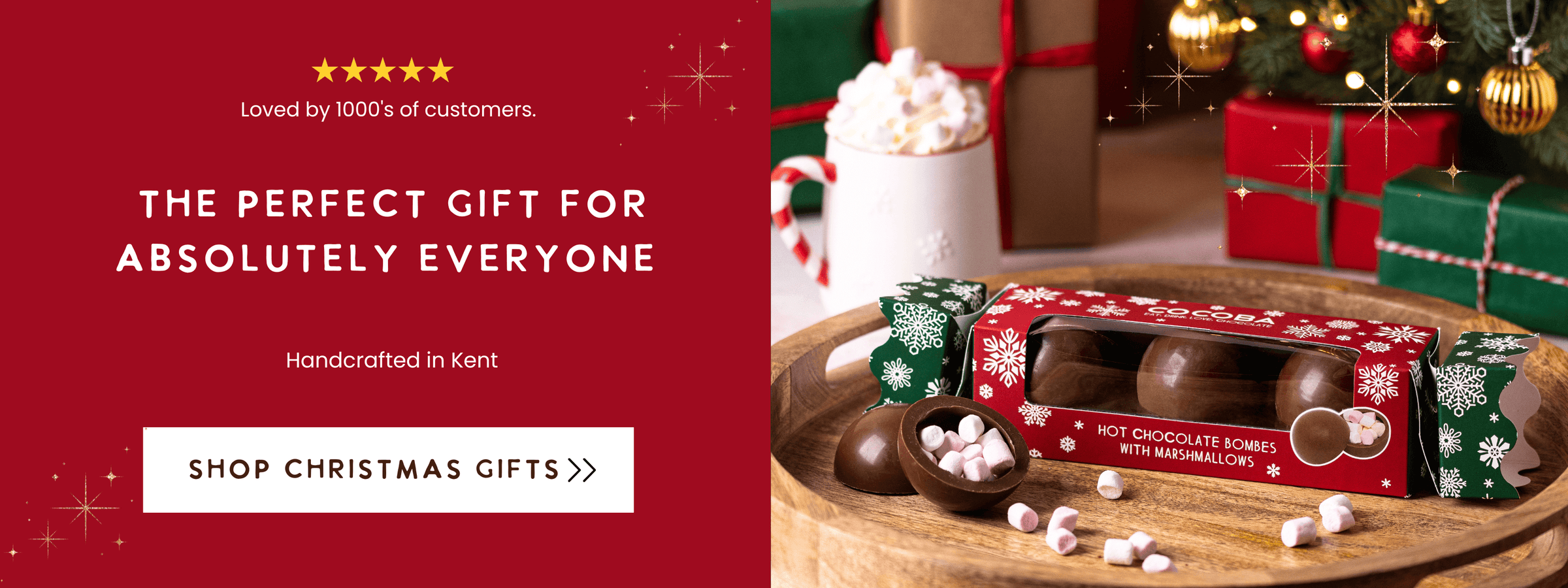 Hot chocolate bombs in a decorative box with a festive background, including a Christmas tree and presents.