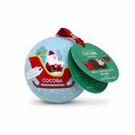 A round Santa-themed chocolate ornament in light blue with white snowflake speckles, featuring an illustration of Santa in a red sleigh. A red ribbon is tied at the top, and two hanging tags read COCOBA and MILK CHOCOLATE BONDE with marshmallows.