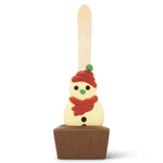 A novelty chocolate hot cocoa stick in the shape of a snowman wearing a red hat and scarf, set in a hot chocolate base on a white background.