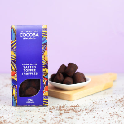 Box of Cocoba salted toffee truffles on a light surface with a purple background