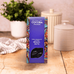 Dark Chocolate Covered Brazil Nuts on a wooden background. 