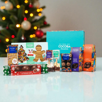 Cocoba chocolate products with a Christmas tree in the background