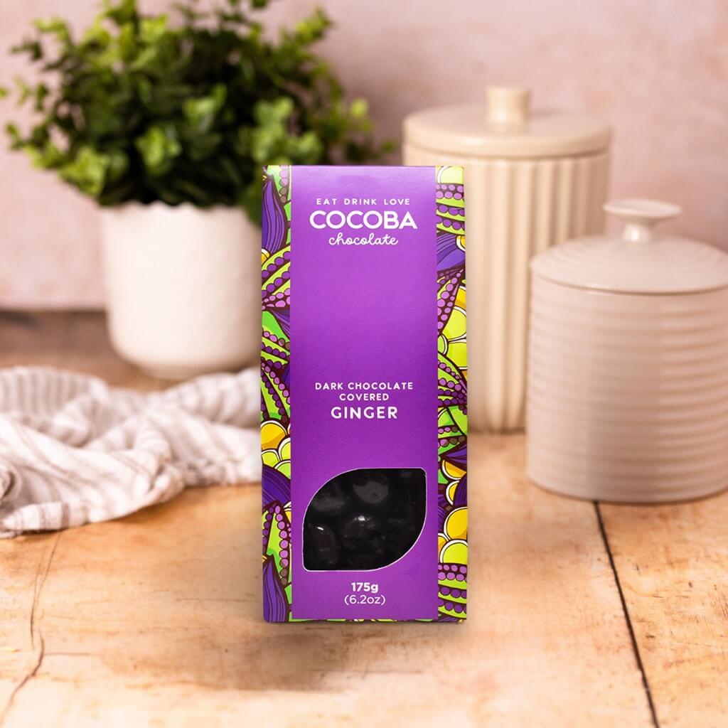 Cocoba chocolate packaging on a wooden surface with decorative items in the background