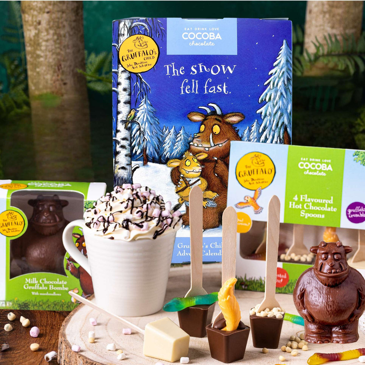 Gruffalo Hot chocolate set with cocoa bombs, spoons, and a mug on a wooden surface.