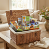 Wicker gift basket with pet products on a wooden table in a living room.