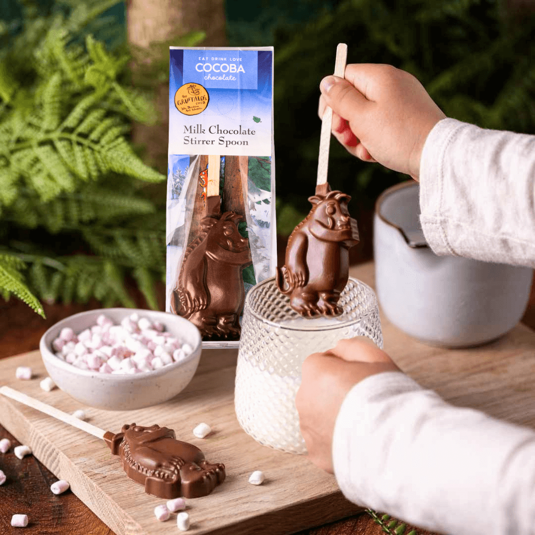 Gruffalo hot chocolate stirrer with a glass of warm milk on a forest themed background