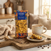 Cocoba chocolate bar with honeycomb on a wooden cutting board next to a cup of coffee.