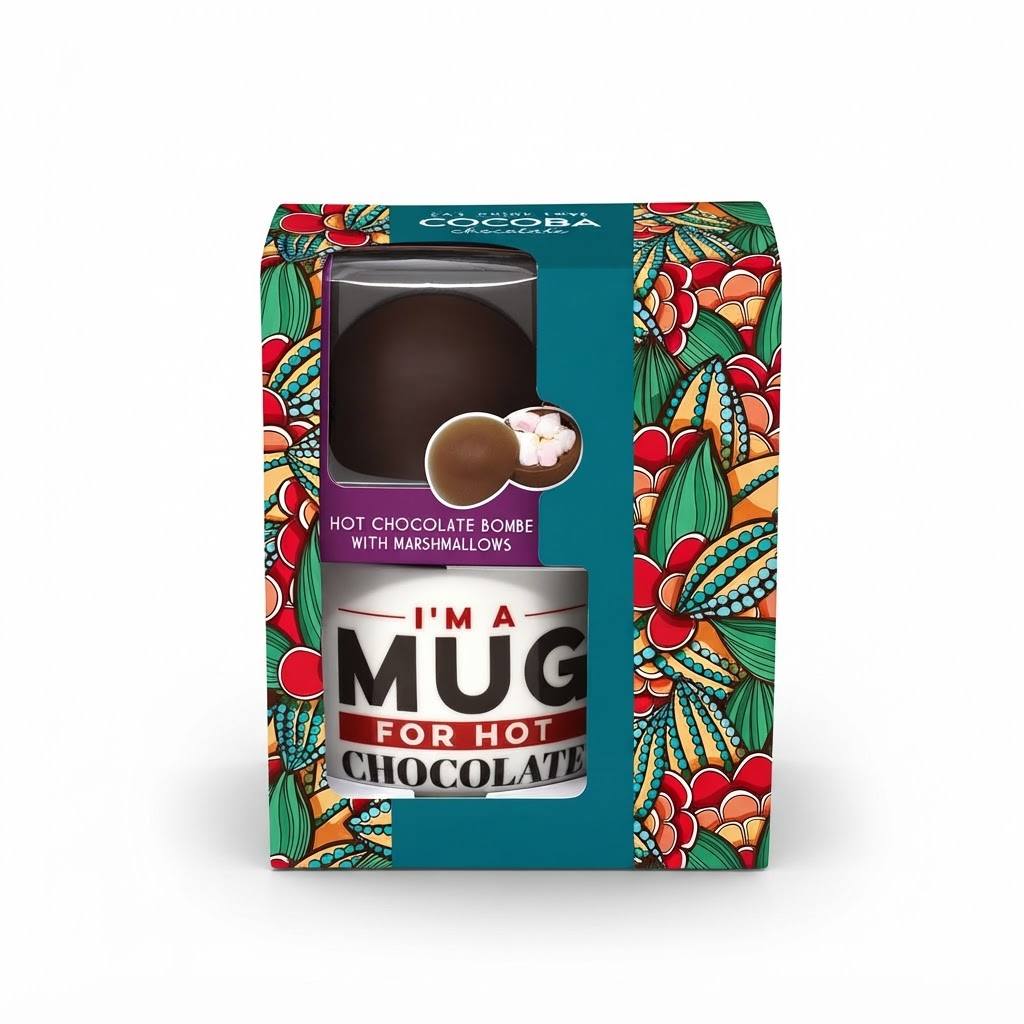 A boxed chocolate product on a white background. The package is decorated with a colorful tropical floral pattern and features a clear window showing a hot chocolate dome inside.