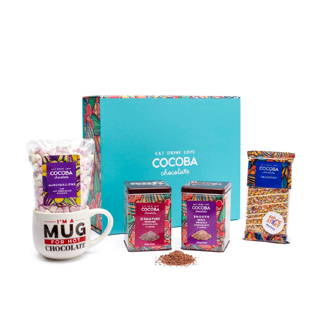 Cocoba chocolate gift set with mug, packets, and boxes on a white background