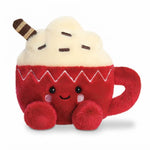 A red plush toy shaped like a hot chocolate cup with a cream-colored whipped topping, brown striped swirl, and embroidered facial features on a white background.