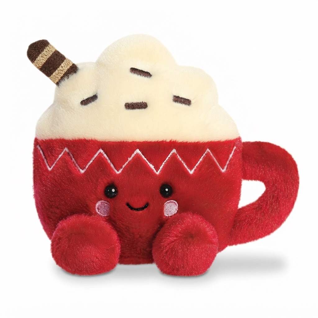 A red plush toy shaped like a hot chocolate cup with a cream-colored whipped topping, brown striped swirl, and embroidered facial features on a white background.