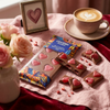 Jelly Hearts Milk Chocolate Bar on a table with a cup of coffee