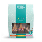 Cocoba Chocolate Kids Hot Chocolate Spoons in a light blue and teal bag with a clear window showing three chocolate spoons filled with sprinkles, candy beans, and marshmallows.
