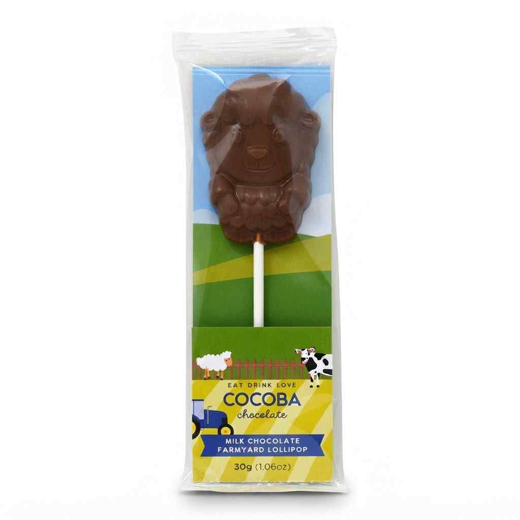 A packaged milk chocolate lollipop shaped like a farmyard animal, shown in a clear plastic sleeve with a printed backing card. The visible text includes 'COCOPA chocolate' and 'Milk Chocolate Farmyard Lollipop.