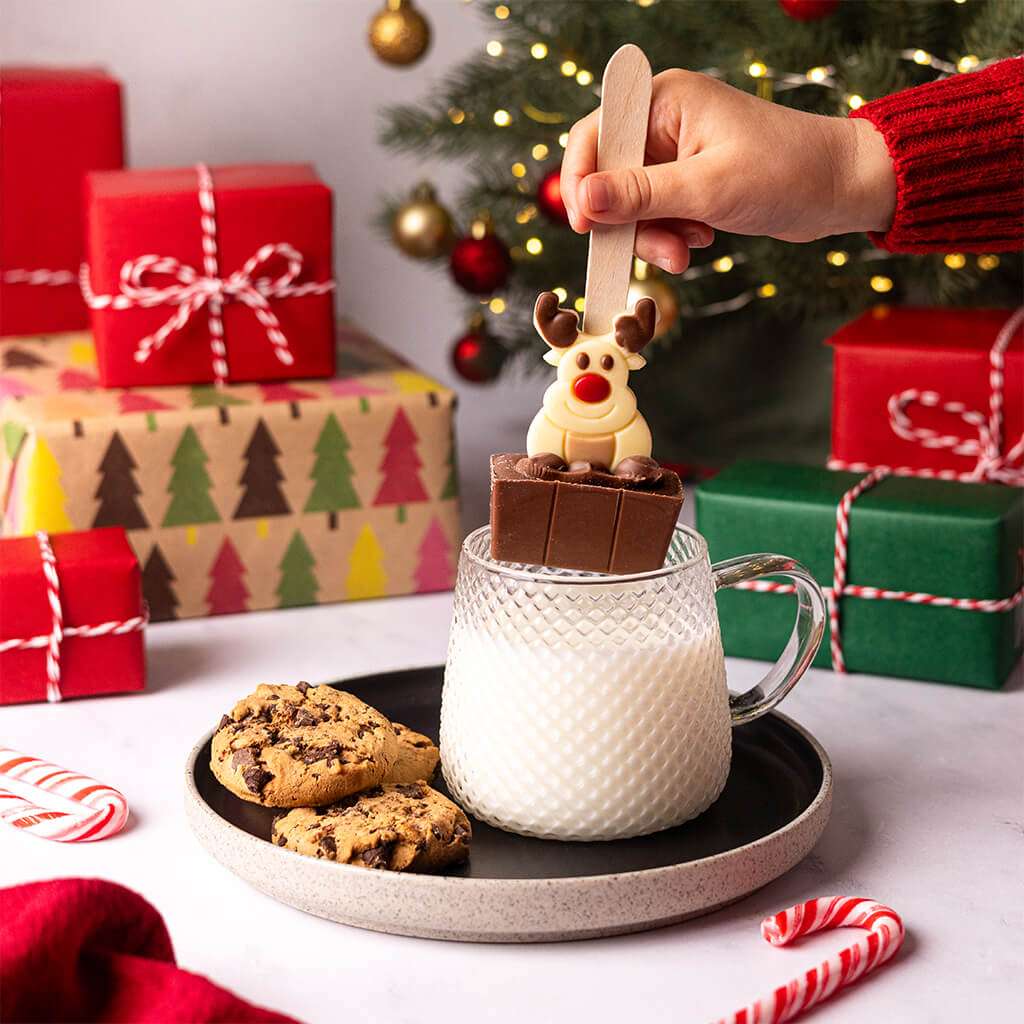 Milk Chocolate Christmas Hot Chocolate Spoon with White Chocolate Reindeer in a mug of hot milk