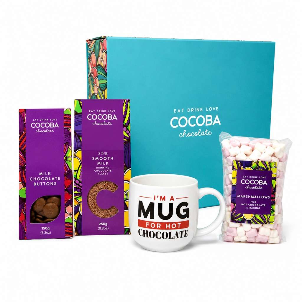 Cocoba Chocolate gift set featuring a turquoise gift box, milk chocolate buttons, 35% smooth milk chocolate flakes, a bag of marshmallows, and a white ceramic mug that reads 'I'M A MUG FOR HOT CHOCOLATE'.