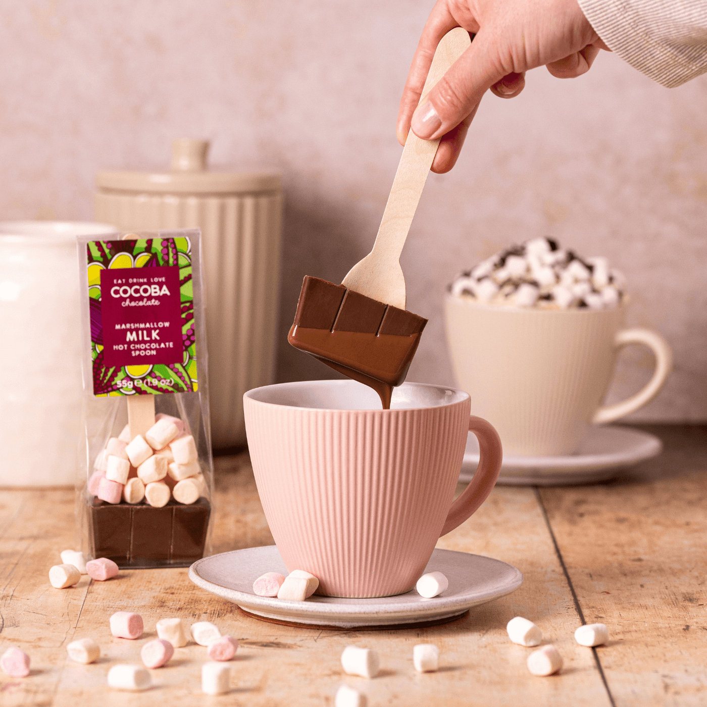Milk hot Chocolate spoon, dripping with chocolate and a mug