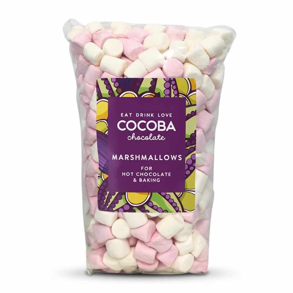 A clear plastic bag filled with pink and white mini marshmallows, with a purple label reading 'COCOPA chocolate MARSHMALLOWS FOR HOT CHOCOLATE & BAKING'.