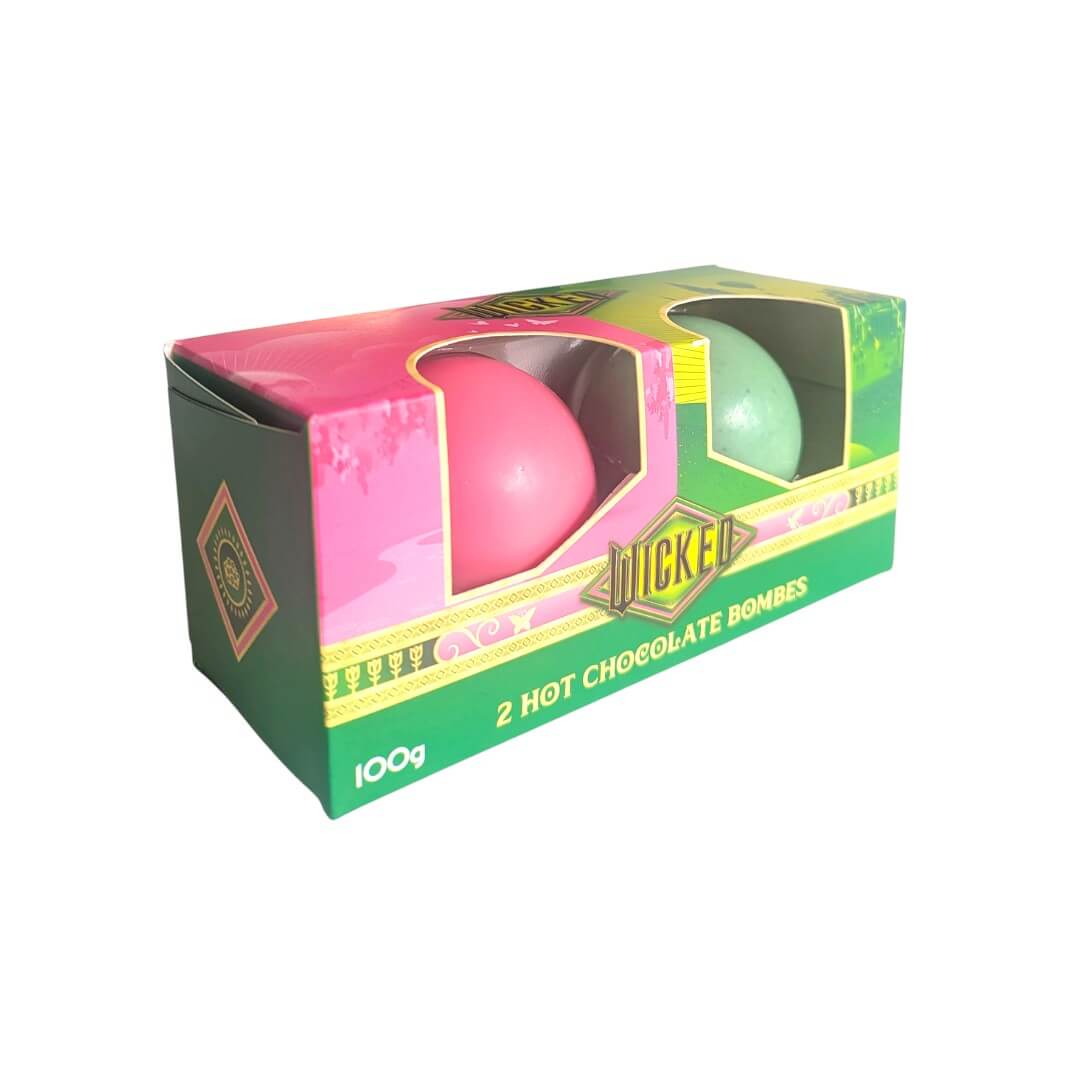 Box of Hot Chocolate Bombs with pink and green spheres on a white background