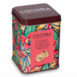 A square metal tin of COCOBA Raspberry & Marc de Champagne Truffles, featuring a vibrant multicolor floral and paisley pattern, a dark brown lid, and a pink label on a white background.