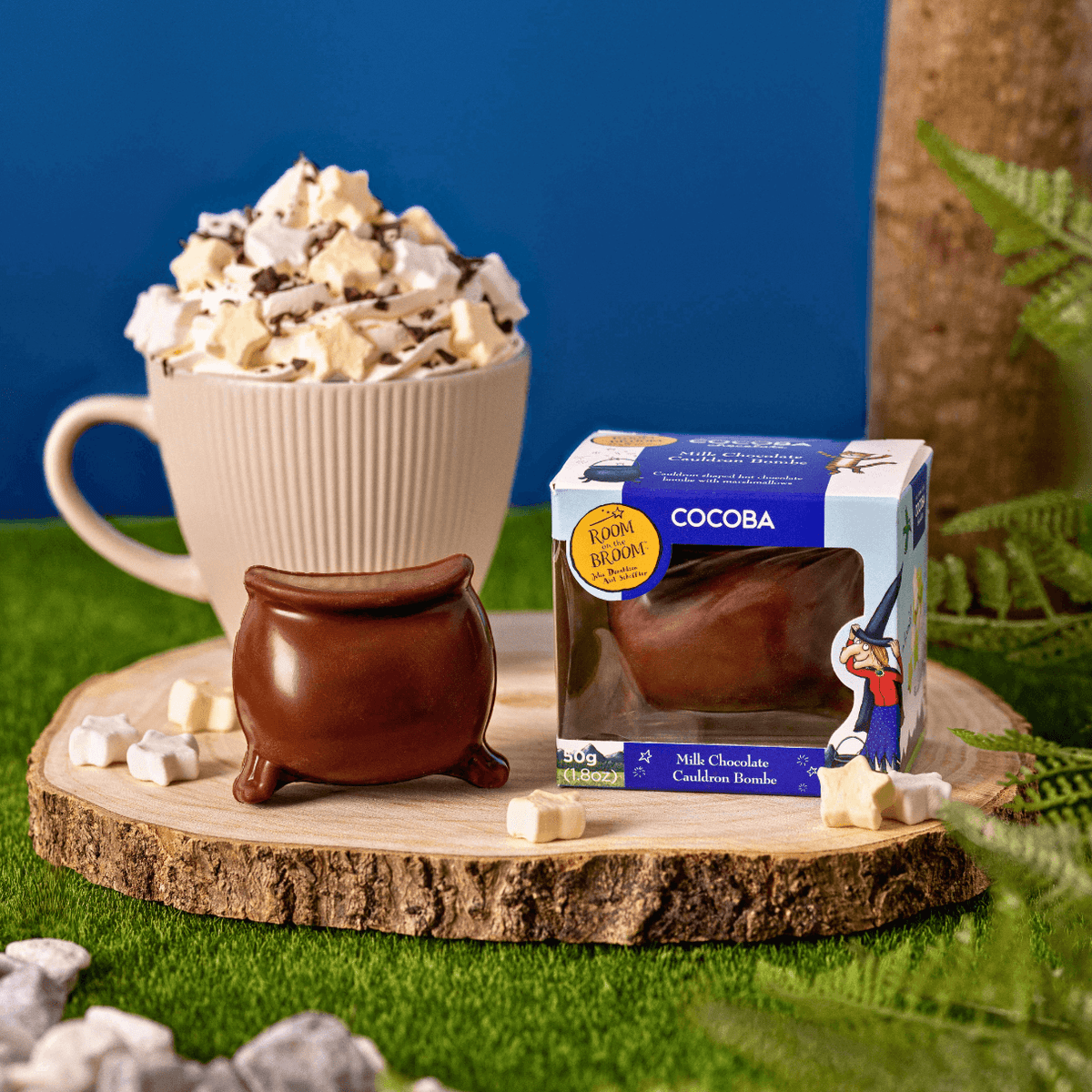 COCOBA chocolate bomb packaging with a mug of hot chocolate and marshmallows on a wooden stand.