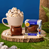 COCOBA chocolate bomb packaging with a mug of hot chocolate and marshmallows on a wooden stand.
