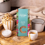 Salted Caramel Drinking Chocolate Flakes in a cosy setting with a Salted Caramel hot chocolate. 