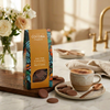 Cocoba chocolate saleted caramel buttons on a kitchen counter with a cup of coffee and chocolate buttons.