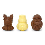 Three small molded chocolate figures on a white background: a brown reindeer on the left, a pale yellow snowman in the center, and a brown Santa Claus on the right.