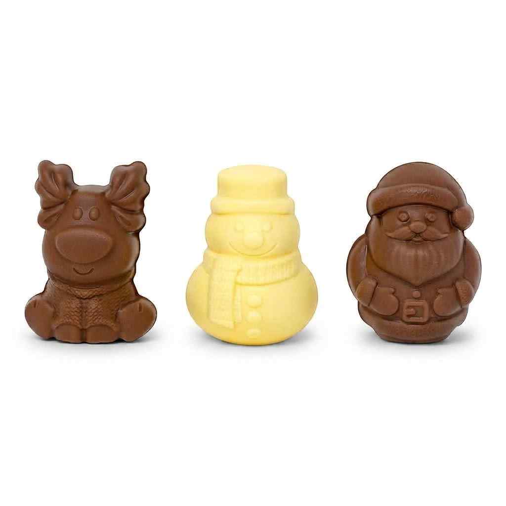 Three small molded chocolate figures on a white background: a brown reindeer on the left, a pale yellow snowman in the center, and a brown Santa Claus on the right.