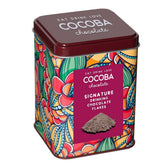 Colorful tin of Cocoba chocolate with decorative design and label.