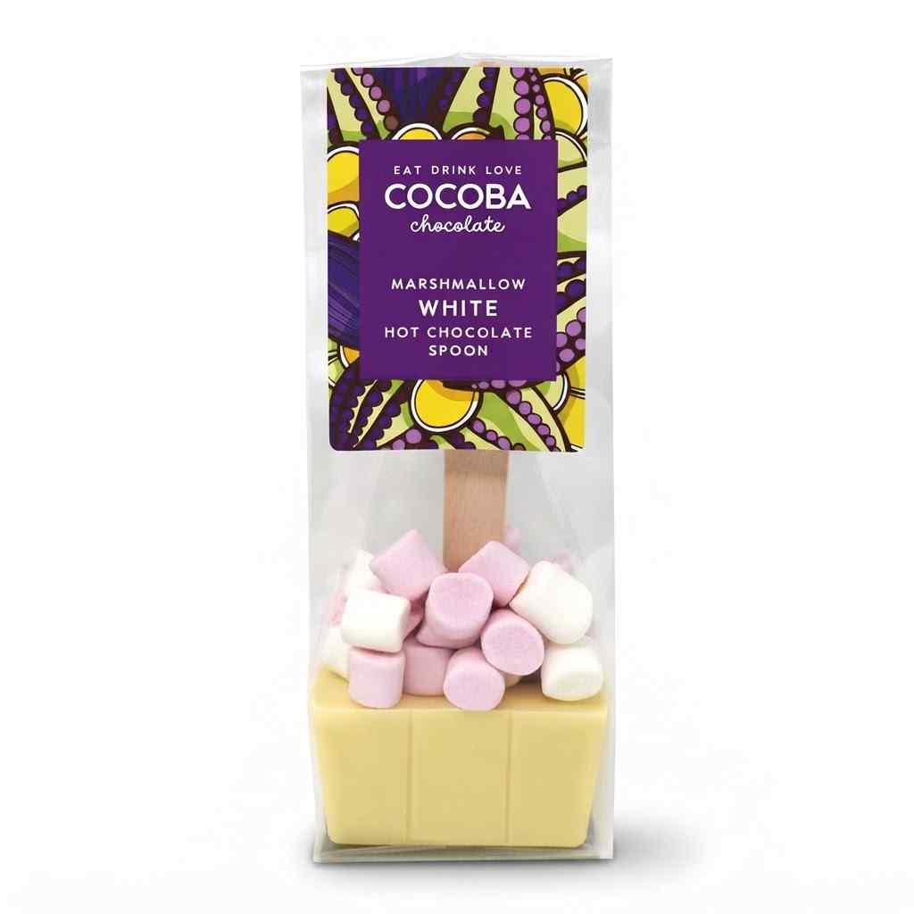 A packaged hot chocolate spoon from Cocoa Chocolate, featuring a pale yellow chocolate base with pink and white marshmallows on top, inside a clear bag with a purple label.