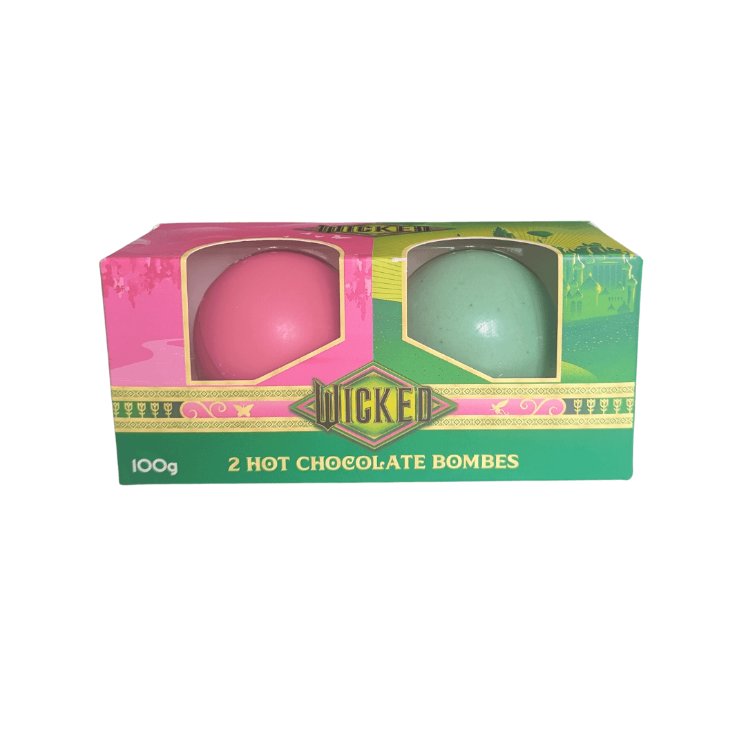 one pink and one green hot chocolate bombe in wicked packaging on a white background.