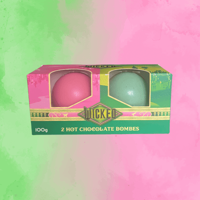 Box of Wicked hot chocolate bombs with two colorful spheres on a gradient background