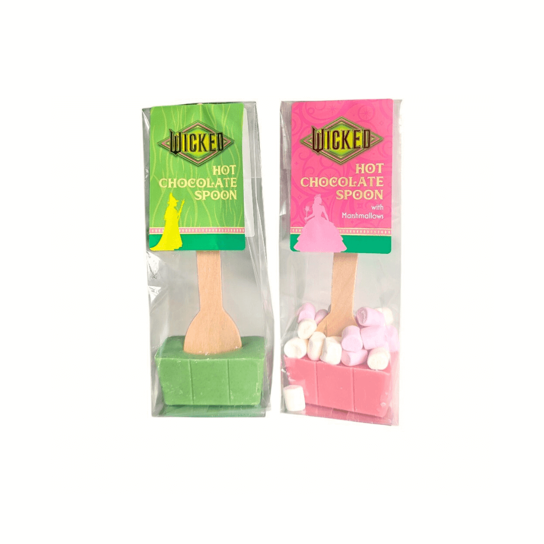 one green and one pink wicked themed hot chocolate spoons on a white background.