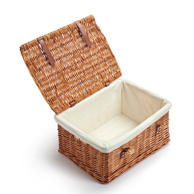 Wicker storage basket with a white interior on a white background
