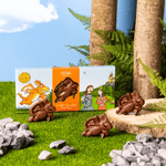 Zog Chocolate Bites on a green grass and blue sky background. 