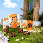 Zog Chocolate Bundle on a woodland background with three zog bites out of the packaging. 