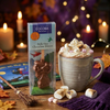 COCOBA hot chocolate stirrer with a mug of hot chocolate and marshmallows on a festive background.