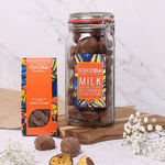 Jar of Cocoba milk chocolate covered honeycomb with a refill box next to it. on a light background