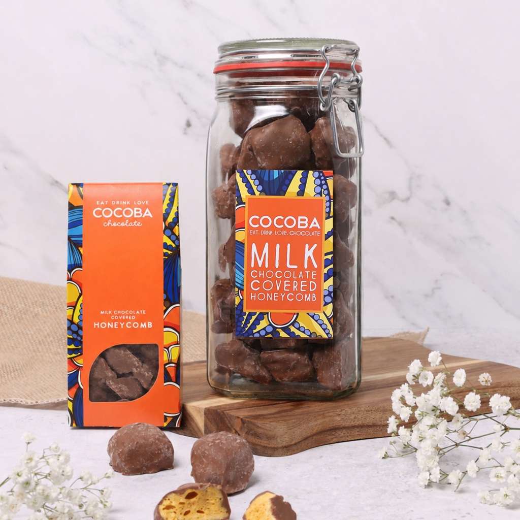 Jar of Cocoba milk chocolate covered honeycomb with a refill box next to it. on a light background